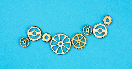  Wooden cogwheels on blue background