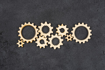  Wooden cogwheels on black background