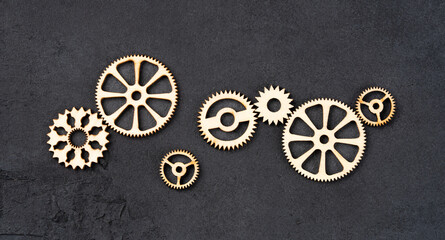  Wooden cogwheels on black background