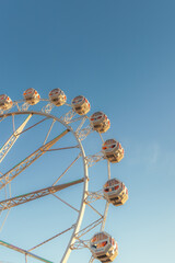 A Ferris wheel against the blue sky in the park