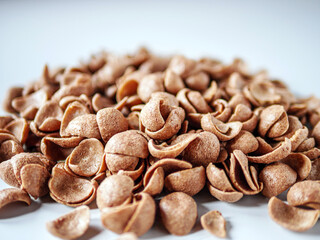 Chocolate cereals corn flakes on white background
Cornflakes pile for breakfast, heap of brown...