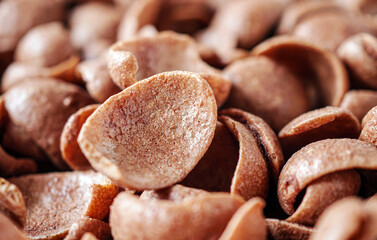Chocolate cereals corn flakes close-up of Cornflakes pile for breakfast, heap of brown choco...