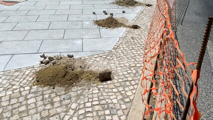 Crumbled cobblestones whisper construction secrets in urban renewal maze, echoing Dia do...