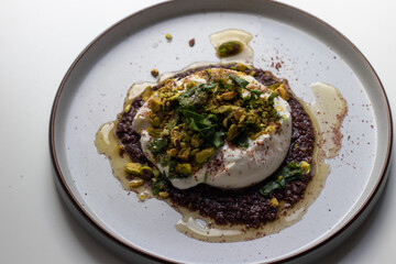 Burrata, olives, herbs. sumac, pistachios