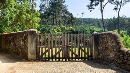 A sunbaked rustic gate whispers secrets of midsummer solstice gatherings and ancient harvest rituals in the serene woodland