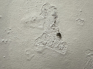 Worn white wall damage close-up