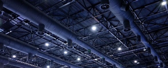 Black insulation air duct install on the ceiling of the structure and are used to deliver cool air from the HVAC air conditioning system of large buildings