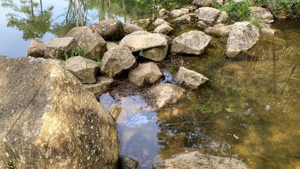 Rocky whispers in tranquil stream, natures Zen puzzle, evoke serenity and rebirth, ideal for Earth...
