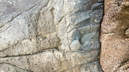 Ancient stone surface reveals rugged textures, echoing tales of Earths silent fury; perfect for Geologists' Day or Earth Science Week