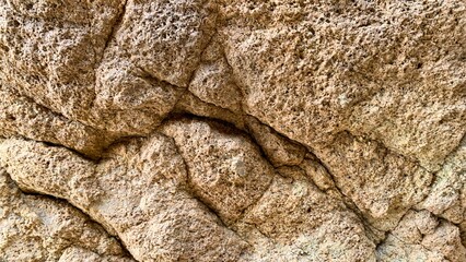 Crumbling ancient sandstone whispers prehistoric secrets, embracing rugged earth textures, invoking National Sandcastle Day and Geologist Appreciation Week