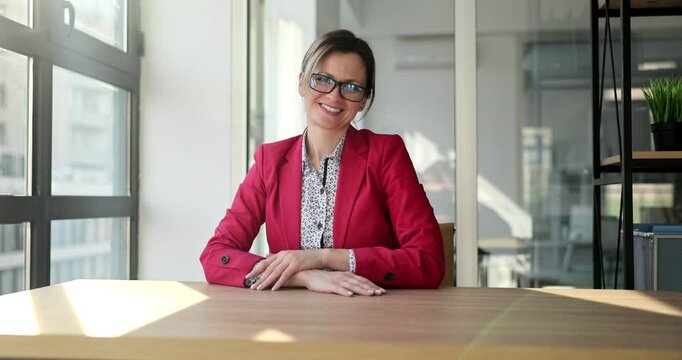Businesswoman sitting at desk sweeps off crumpled papers scattered around Frustration after intense brainstorming session in modern office slow motion