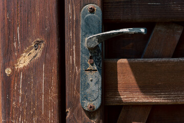 old vintage door handle and lock on wooden door