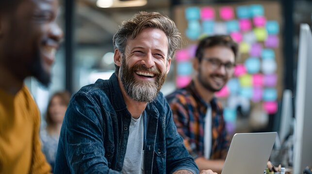 Cheerful colleagues collaborating in a vibrant office space, fostering teamwork and innovation in a modern work environment.