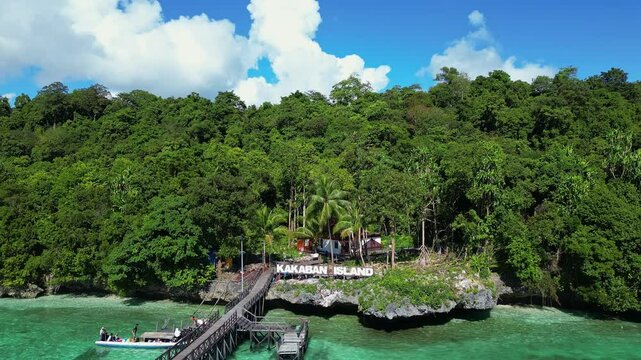 Kakaban, Indonesia: Aerial view of the Kakaban island near Maratua island in the Derawan archipelago in Kalimantan in Indonesia. Shot with an upward and time wrap motion up to the interior lake