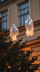 Illuminated Ghost Decorations Hanging on Building During Christmas Season