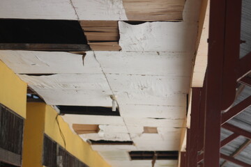The deck of a building is old and badly damaged,
