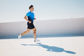 Running towards the horizon under a clear blue sky at midday, showcasing determination and athletic...