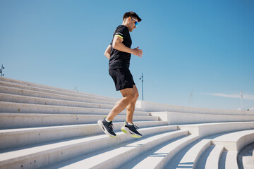 Running down modern stairs under a clear blue sky, a vibrant display of athletic energy and...