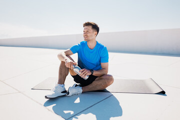 Relaxing and rehydrating after an intense workout on a sunny rooftop in the morning