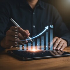 Person using stylus on tablet to analyze upward trending financial growth chart