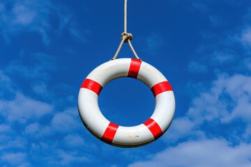 Life Buoy Floating Against a Bright Blue Sky with Clouds