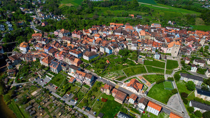 A panoramic aerial view around the old town of the city Orbe in Switzerland on a sunny spring noon