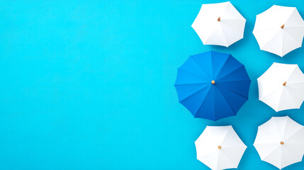 Top view of five white umbrellas and one blue umbrella on a bright blue background.