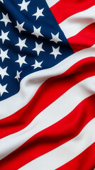 Close-up of the American flag waving, showing stars and red and white stripes in vibrant colors.
