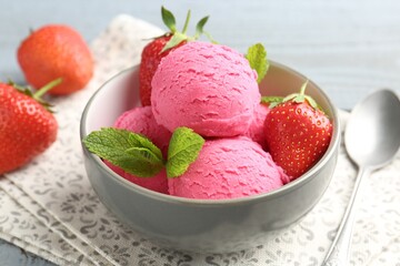 Tasty sorbet with strawberries and mint served on grey wooden table, closeup
