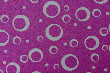 Paper texture with ornament. Decorative cardboard sheet with circles. Pink geometric background	