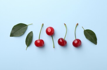 Fresh ripe cherries on light background, flat lay