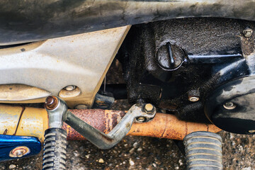 Old and expired motorcycle oil filler cap is loose and evaporated motorcycle engine oil stains....