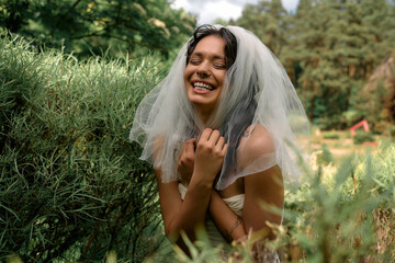 Young woman in white dress joyfully enjoying a sunny summer day in nature