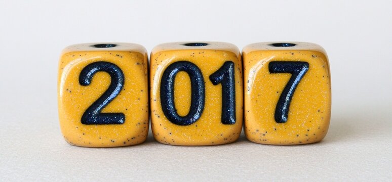 Colorful Yellow Dice Displaying the Year 2017 on a Light Background