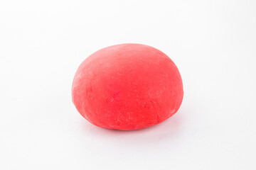 Traditional Japanese mochi dessert in bright red color on a clean white background. Minimalist food photography with copy space for design or advertising use