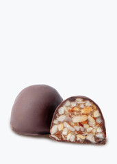 Isolated chocolate candy with visible cross-section showing chopped nuts and dried fruits inside. The product is coated in dark chocolate and placed on a clean white background. Ideal for catalogs