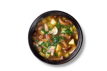 Flat lay of hot homemade mushroom soup with chopped herbs, diced potatoes and assorted mushrooms in...