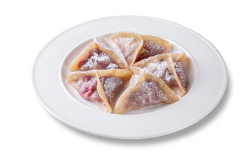 Freshly cooked cherry-filled dumplings served on a white plate, topped with powdered sugar. Traditional Eastern European dessert. Soft dough and juicy berry filling