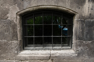 window with bars in a house made of black tuff, Gyumri, Armenia