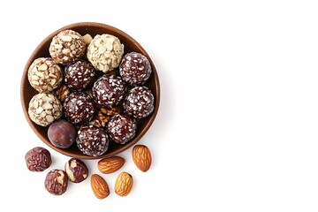 Obraz premium Delicious energy balls presented in a wooden bowl with almonds and dates on a white background