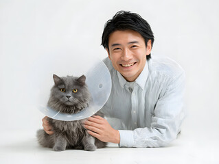 man kneeling next to his cat who is wear