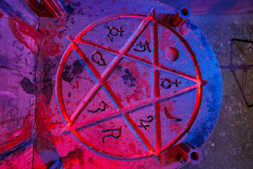 A pentagram with fire in a dark room. Quest