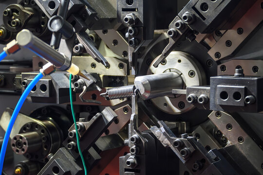Close up operation of the wire coil spring making machine.