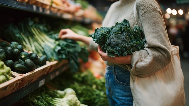 A shopper selects fresh kale and other vegetables while browsing the produce section in a grocery store.