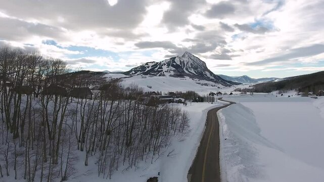Aerial of road leading among winter landscape of Crested Butte