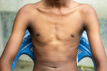 A young man shows his chest and two nipple