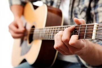 Obraz premium Hands of a musician playing an acoustic guitar close up.
