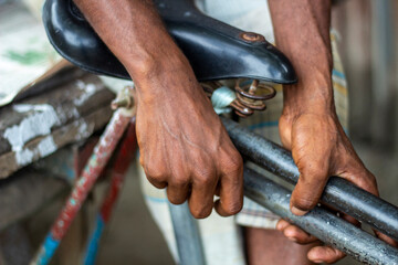 A young man is holding the iron pipe his both hands