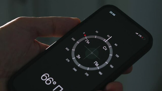 Hiking and orientation on the landscape using a compass.
A man with a compass in his hands is walking in the right direction and in the right direction