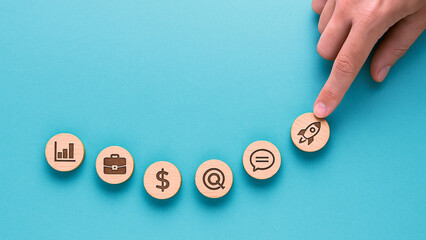 Business-themed icon set featuring briefcase, dollar sign, chat bubble, and rocket being touched by a finger, symbolizing startup growth, financial planning, and interactive communication